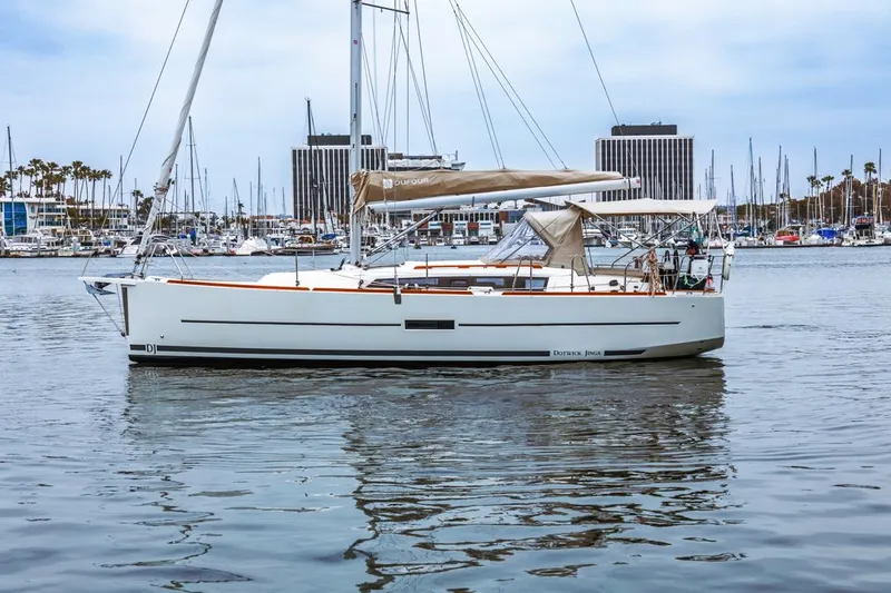 Dotwick Jinga Yacht Photos Pics 2020 Dufour 360 sailboat docked in a marina with calm waters.