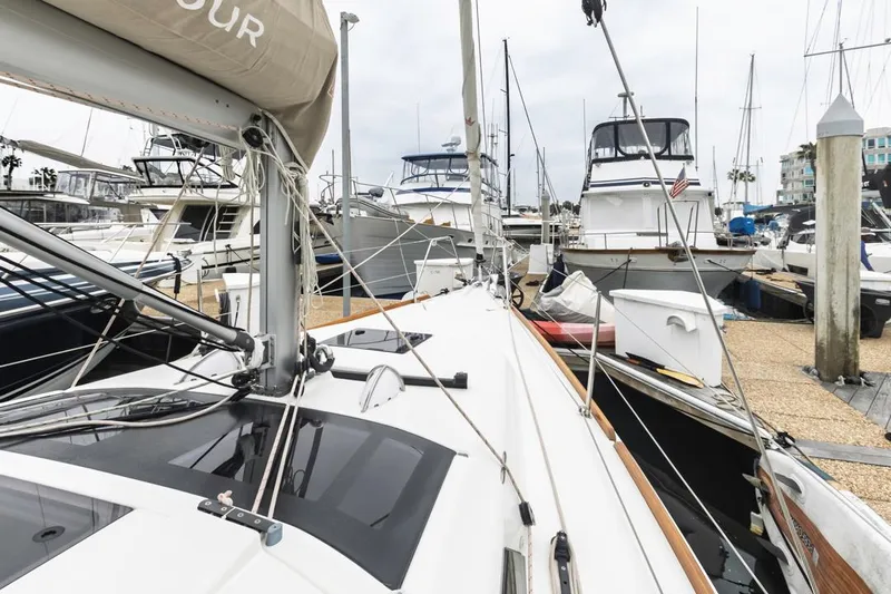 Dotwick Jinga Yacht Photos Pics 2020 Dufour 360 sailboat docked in a marina, surrounded by other boats.