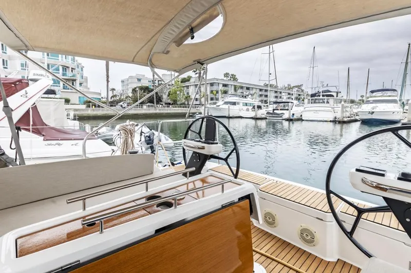 Dotwick Jinga Yacht Photos Pics 2020 Dufour 360 sailboat cockpit with dual steering wheels in a marina setting.