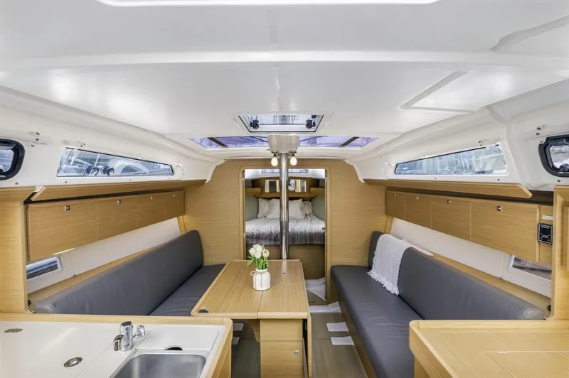 Dotwick Jinga Yacht Photos Pics Modern interior of 2020 Dufour 360 sailboat with cozy seating and wooden finishes.