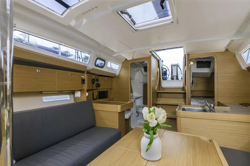 Dotwick Jinga Yacht Photos Pics Interior of 2020 Dufour 360 yacht, featuring modern wood finish and cozy seating area.