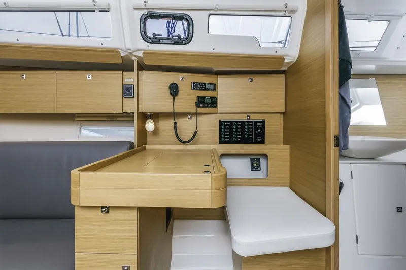 Dotwick Jinga Yacht Photos Pics Interior of 2020 Dufour 360 yacht with navigation station and modern wood finish.