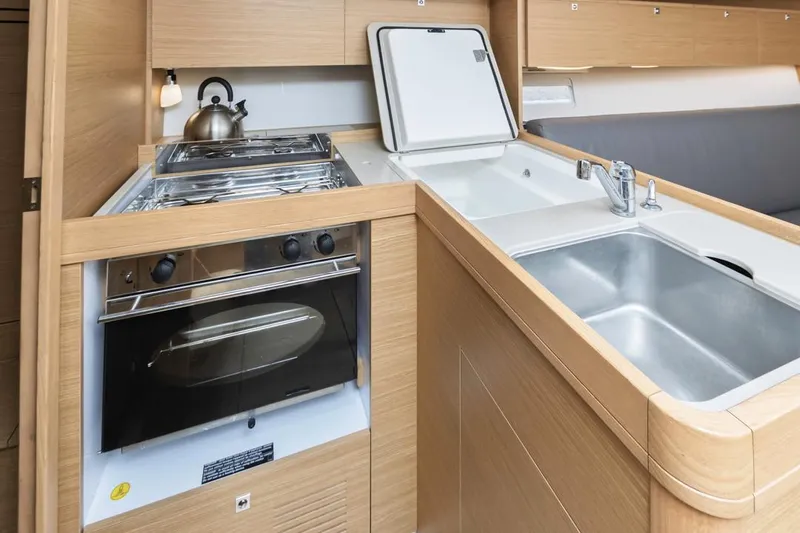 Dotwick Jinga Yacht Photos Pics Modern kitchen in 2020 Dufour 360 yacht with stove, sink, and storage.