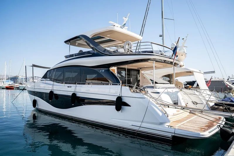  Yacht Photos Pics Luxury 2023 Princess Y72 yacht docked in marina, showcasing sleek design and modern features.