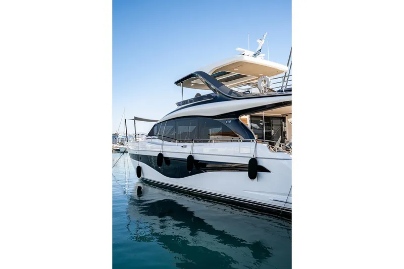  Yacht Photos Pics Luxury 2023 Princess Y72 yacht docked in marina, sleek design, sunny day.
