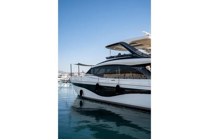  Yacht Photos Pics Luxury 2023 Princess Y72 yacht docked in a serene marina setting.
