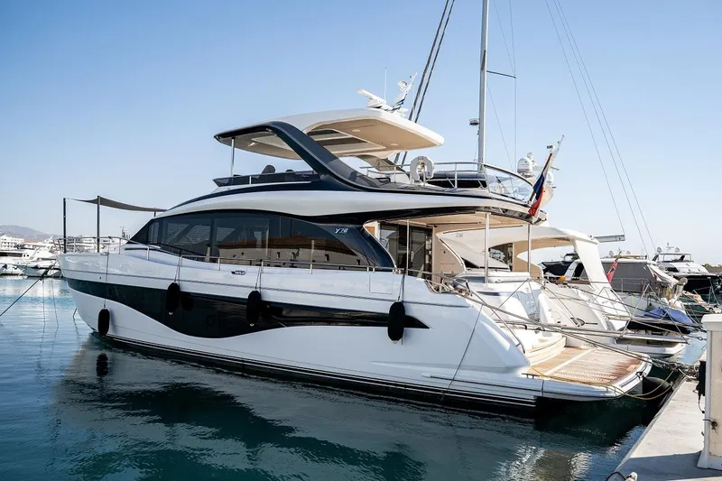  Yacht Photos Pics Luxury 2023 Princess Y72 yacht docked in marina under clear blue sky.