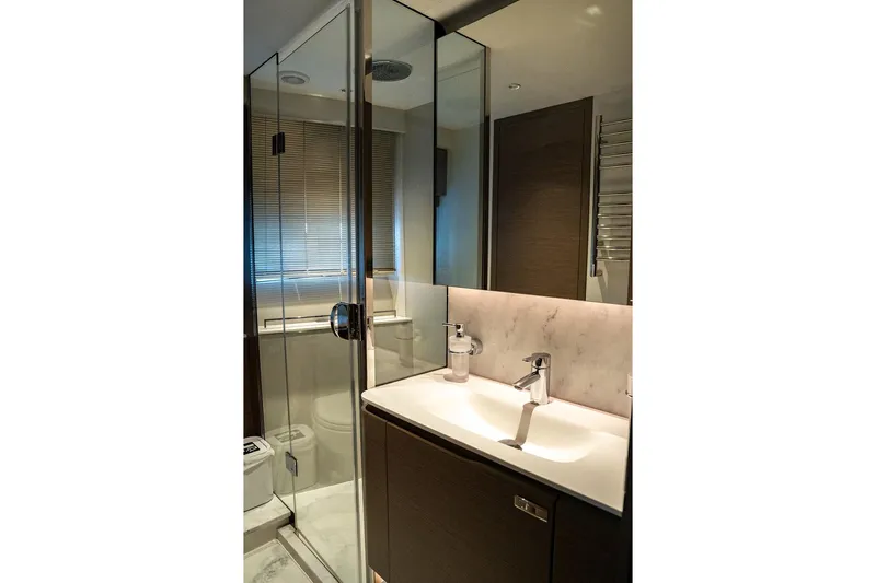  Yacht Photos Pics Luxurious bathroom in 2023 Princess Y72 yacht with modern fixtures and glass shower.