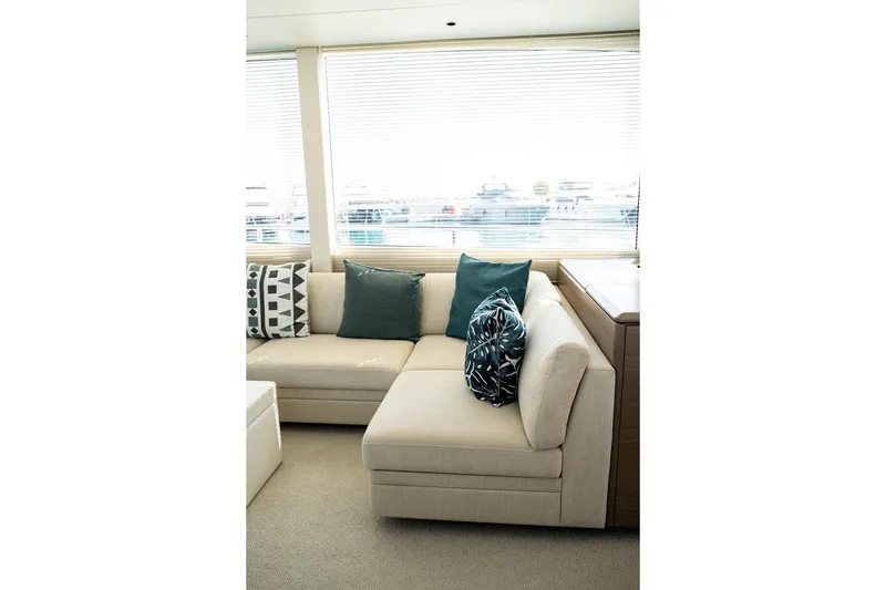  Yacht Photos Pics Luxurious interior of 2023 Princess Y72 yacht with elegant beige sofa and decorative cushions.