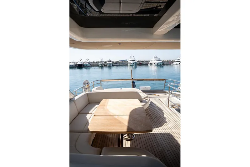  Yacht Photos Pics Luxurious 2023 Princess Y72 yacht deck with seating, overlooking a marina.