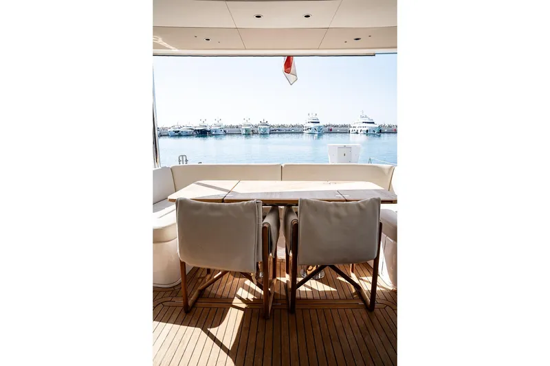  Yacht Photos Pics Luxury yacht Princess Y72, 2023 model, featuring elegant outdoor dining area with marina view.