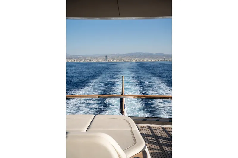  Yacht Photos Pics Aft view from 2023 Princess Y72 yacht, showing wake trail and distant coastline.