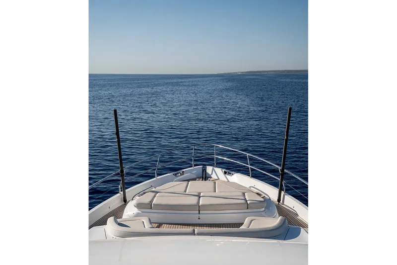  Yacht Photos Pics Luxurious 2023 Princess Y72 yacht cruising on open sea under clear blue sky.