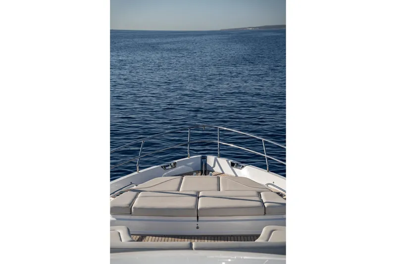  Yacht Photos Pics Bow view of 2023 Princess Y72 yacht on calm ocean waters.