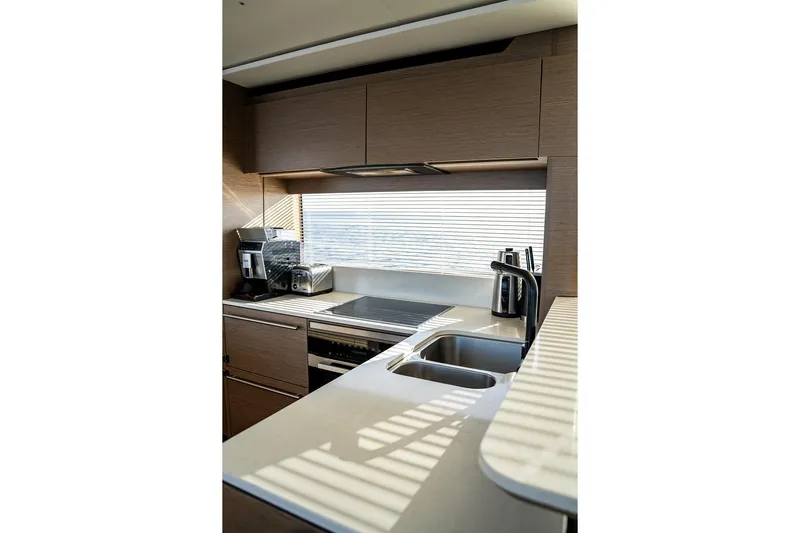  Yacht Photos Pics Modern kitchen interior on 2023 Princess Y72 yacht, featuring sleek appliances and ample counter space.