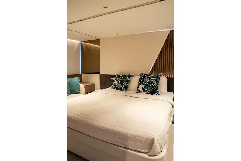  Yacht Photos Pics Luxurious bedroom interior on 2023 Princess Y72 yacht with elegant bedding and decorative pillows.