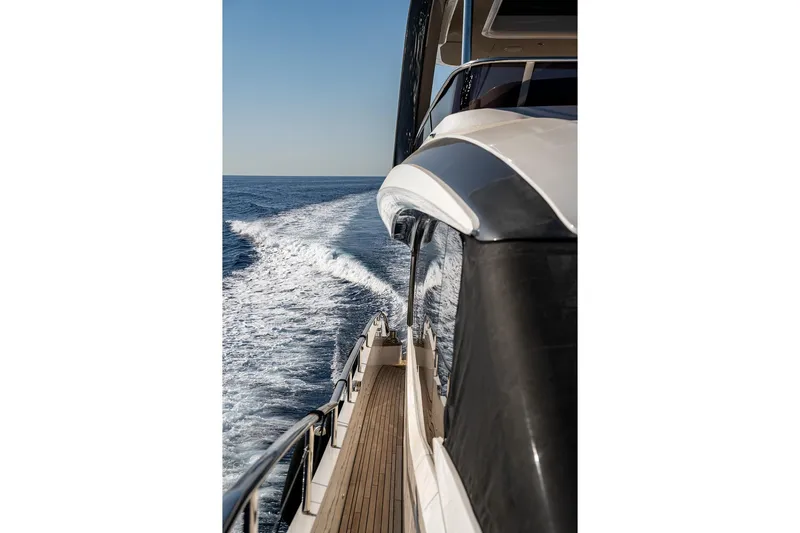  Yacht Photos Pics 2023 Princess Y72 yacht cruising on open sea, leaving a wake behind.