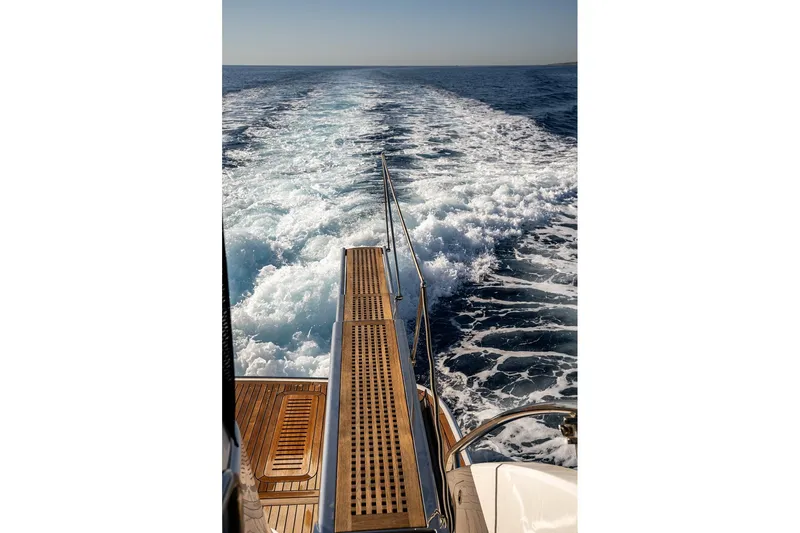  Yacht Photos Pics Sleek Princess Y72 yacht cruising, leaving a foamy wake in the ocean, 2023 model.
