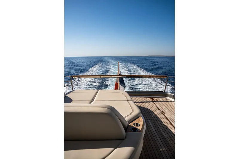 Yacht Photos Pics Luxurious 2023 Princess Y72 yacht cruising on open sea with clear blue skies.