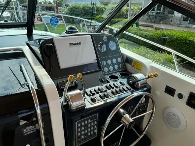 Details Yacht Photos Pics 1998 Tiara Yachts 35 Open helm with navigation controls and steering wheel.