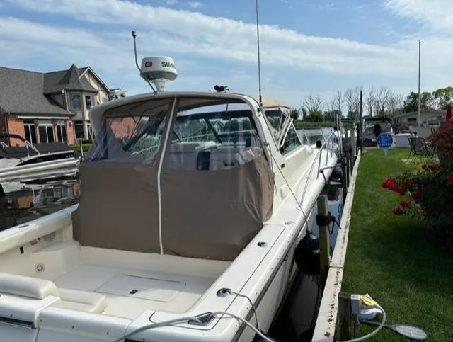 Details Yacht Photos Pics 1998 Tiara Yachts 35 Open docked, featuring a covered cockpit and radar equipment.