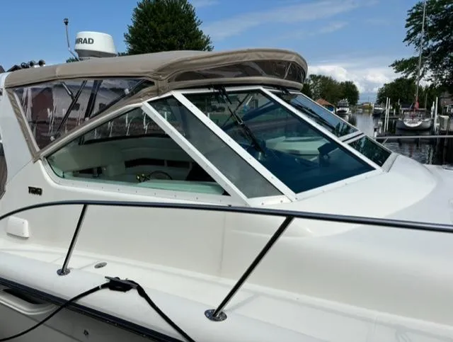 Details Yacht Photos Pics 1998 Tiara Yachts 35 Open boat docked, featuring sleek design and clear windows.