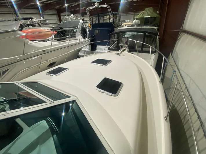 Details Yacht Photos Pics 1998 Tiara Yachts 35 Open in storage, surrounded by other boats.