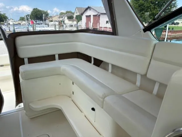 Details Yacht Photos Pics 1998 Tiara Yachts 35 Open interior with white cushioned seating and marina view.