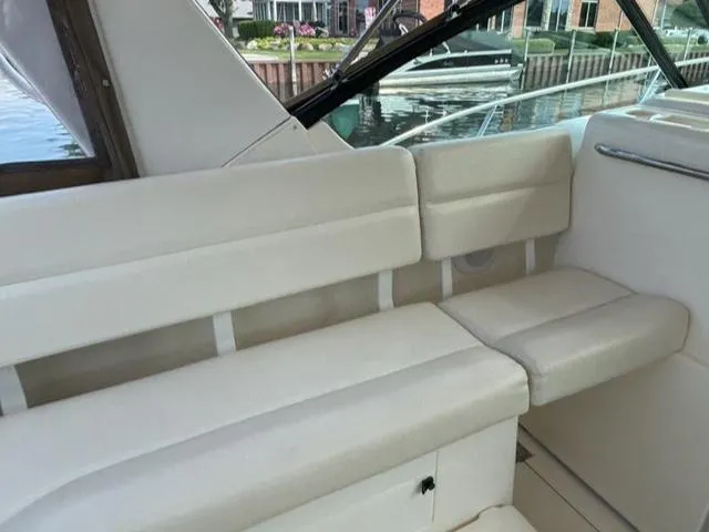 Details Yacht Photos Pics 1998 Tiara Yachts 35 Open interior seating with cream upholstery, dockside view.