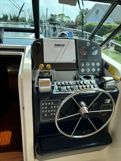 Details Yacht Photos Pics 1998 Tiara Yachts 35 Open helm with steering wheel and navigation controls.