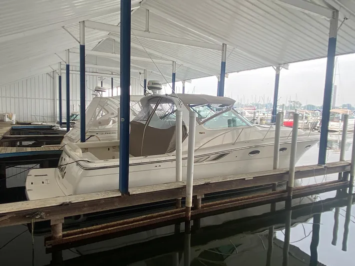 Details Yacht Photos Pics 1998 Tiara Yachts 35 Open docked in a covered marina.