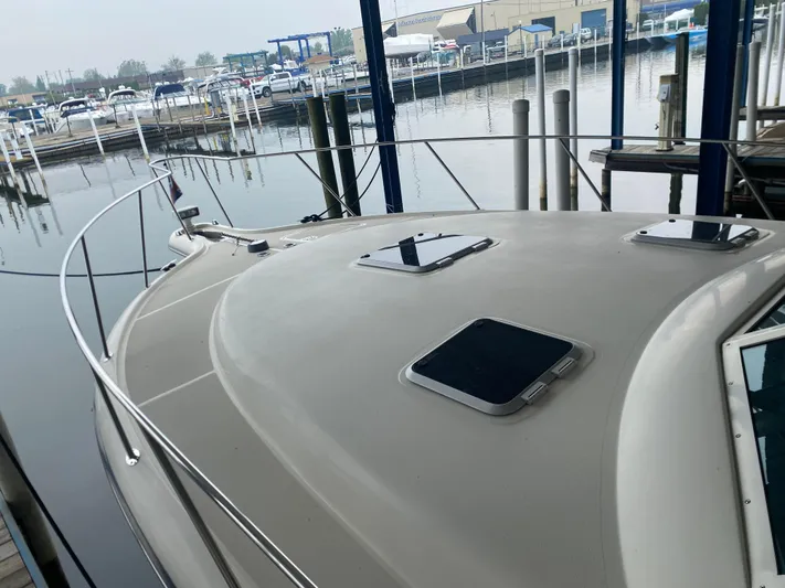 Details Yacht Photos Pics 1998 Tiara Yachts 35 Open docked at marina, showcasing sleek deck design.