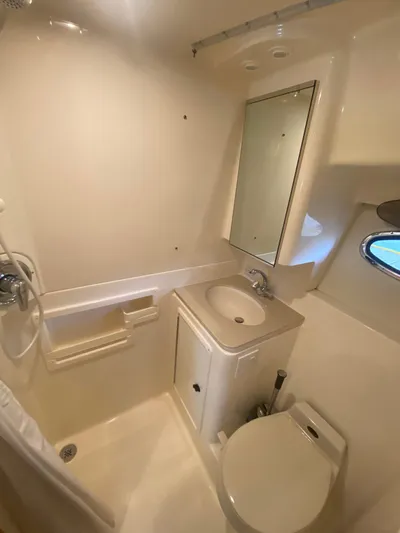 Details Yacht Photos Pics 1998 Tiara Yachts 35 Open bathroom with sink, toilet, and shower.