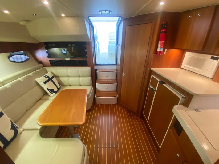 Details Yacht Photos Pics Luxurious interior of 1998 Tiara Yachts 35 Open, featuring cozy seating and modern amenities.