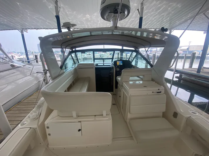 Details Yacht Photos Pics 1998 Tiara Yachts 35 Open boat interior at marina, featuring seating and helm station.