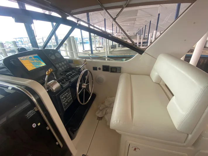 Details Yacht Photos Pics 1998 Tiara Yachts 35 Open helm with steering wheel and navigation display.