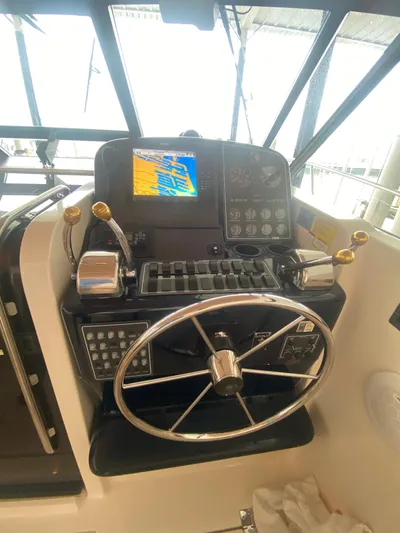 Details Yacht Photos Pics 1998 Tiara Yachts 35 Open helm with navigation controls and steering wheel.