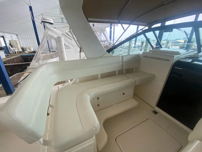 Details Yacht Photos Pics 1998 Tiara Yachts 35 Open interior with white seating and canopy in marina setting.
