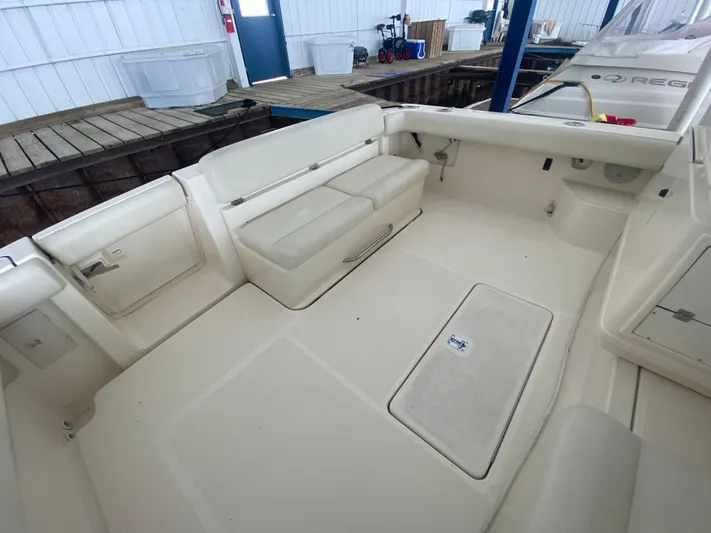 Details Yacht Photos Pics 1998 Tiara Yachts 35 Open boat interior with white seating and storage compartments.
