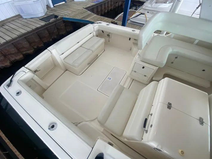 Details Yacht Photos Pics 1998 Tiara Yachts 35 Open cockpit with white seating and storage compartments.