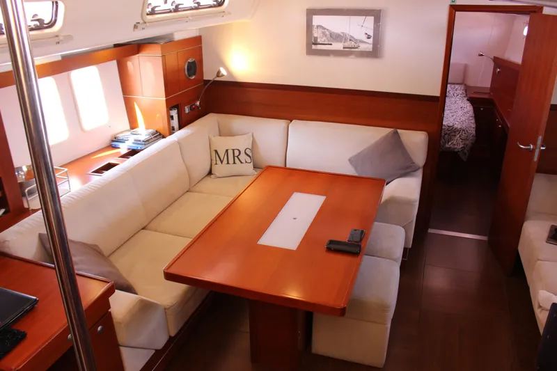  Yacht Photos Pics Luxurious interior of 2010 Hanse 545 yacht with elegant seating and wooden table.