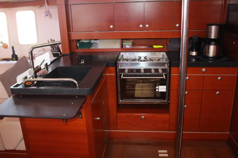  Yacht Photos Pics Luxurious 2010 Hanse 545 yacht kitchen with modern appliances and rich wood cabinetry.
