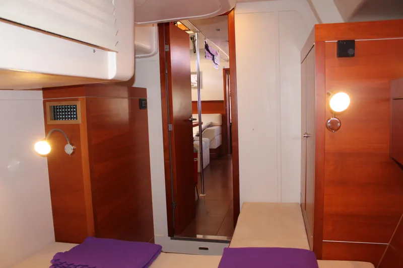  Yacht Photos Pics Interior of 2010 Hanse 545 yacht with wooden cabinetry and cozy lighting.