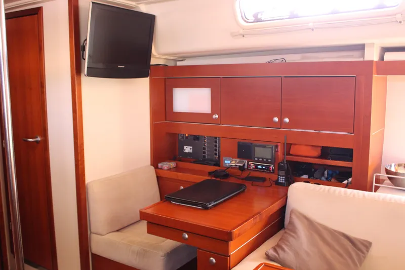  Yacht Photos Pics Interior of 2010 Hanse 545 yacht with wooden cabinetry and seating area.