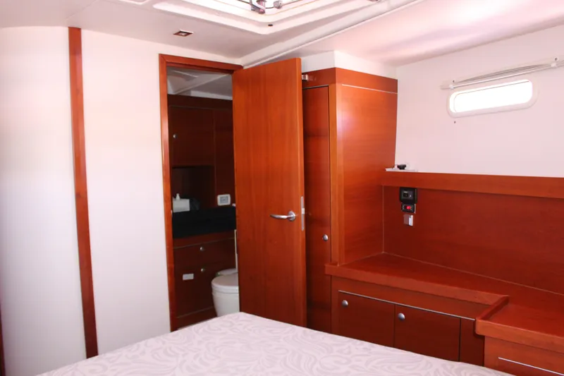  Yacht Photos Pics Interior of 2010 Hanse 545 yacht cabin with wooden furnishings and ensuite bathroom.