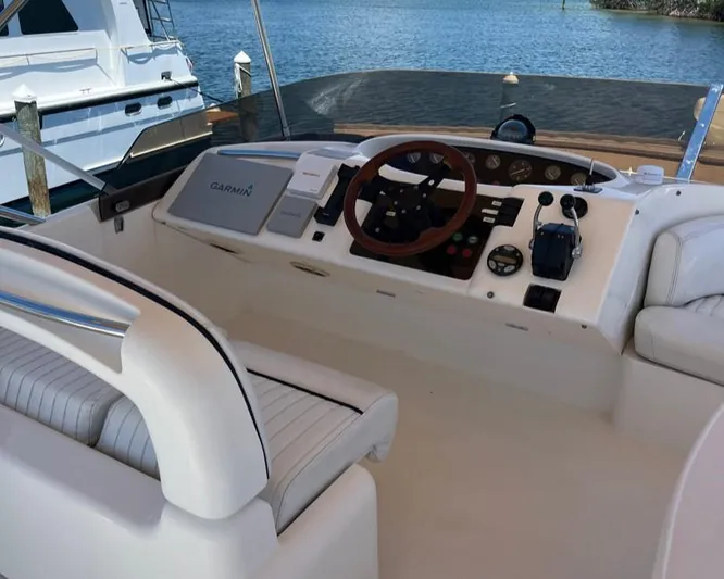 My Girls Too Yacht Photos Pics 1998 Viking Princess 46 Flybridge Sport Cruiser helm with steering wheel and navigation equipment.
