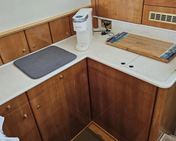 My Girls Too Yacht Photos Pics 1998 Viking Princess 46 Flybridge Sport Cruiser kitchen with wooden cabinets and countertop appliances.