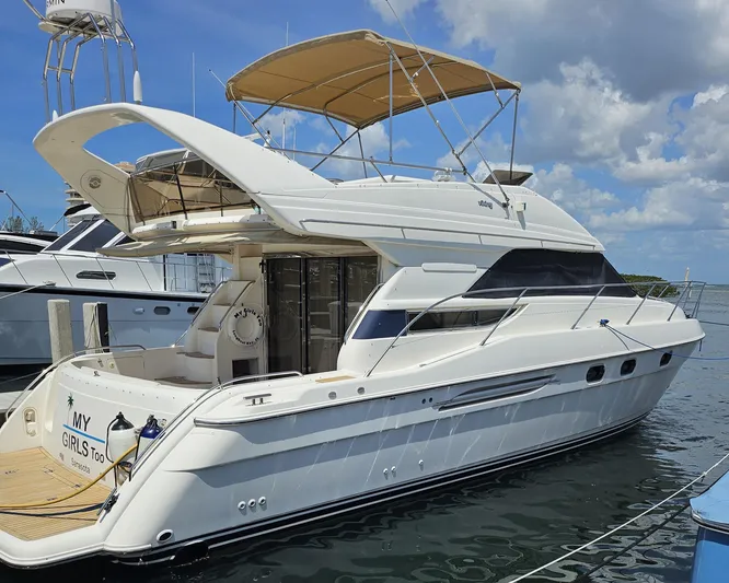 My Girls Too Yacht Photos Pics 1998 Viking Princess 46 Flybridge Sport Cruiser docked under a blue sky.