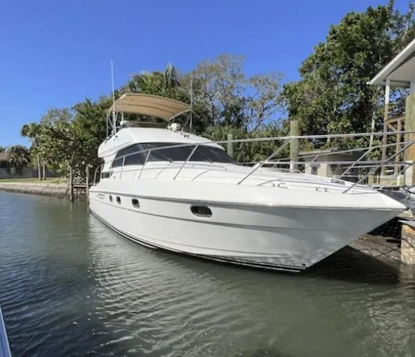 My Girls Too Yacht Photos Pics 1998 Viking Princess 46 Flybridge Sport Cruiser docked in a serene waterfront setting.
