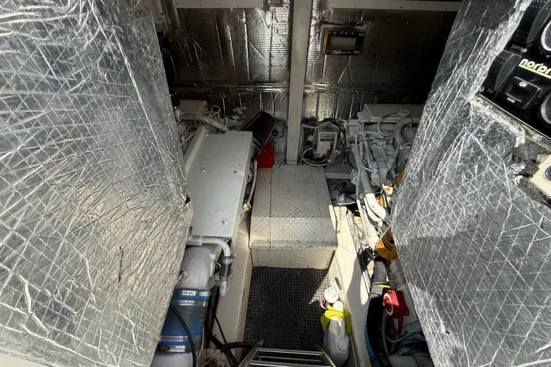  Yacht Photos Pics Engine room of 1999 Ocean Yachts 40 Express, featuring insulated walls and mechanical components.